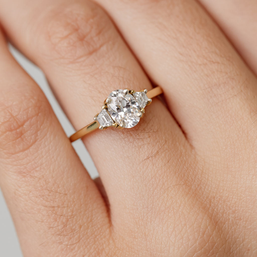 Trilogy three stone engagement ring with oval centre diamond