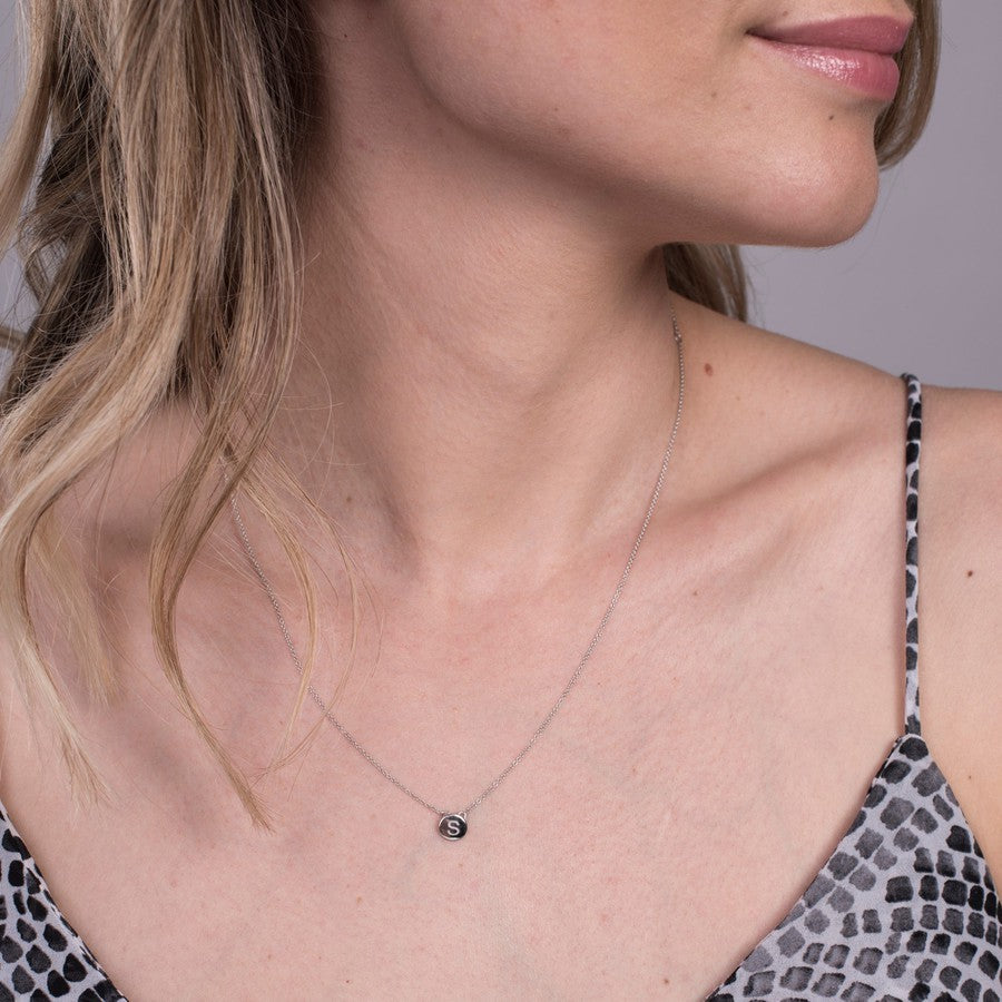 silver disc pendant with engraved letter
