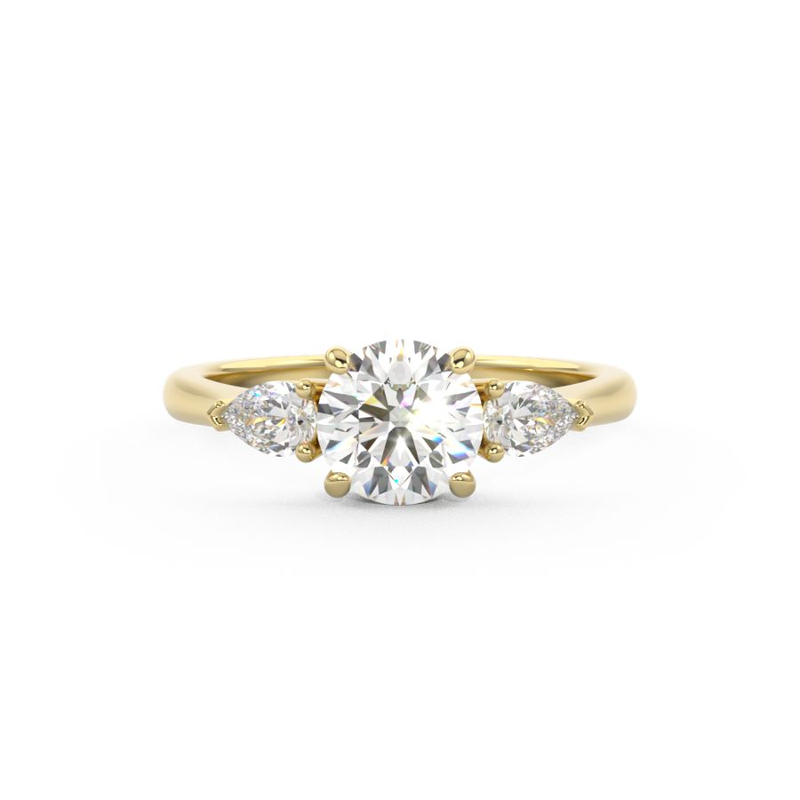 Trilogy ring with a brilliant round cut centre stone and two pear shape diamond side stones