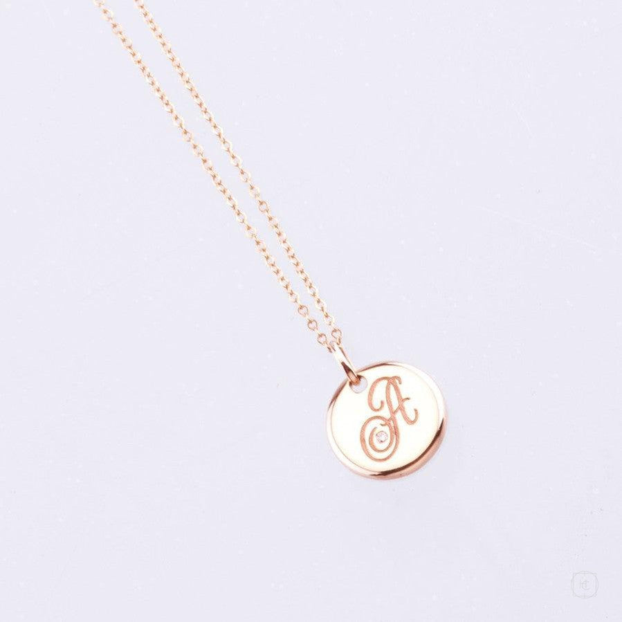 yellow gold disc pendant with engraved letter