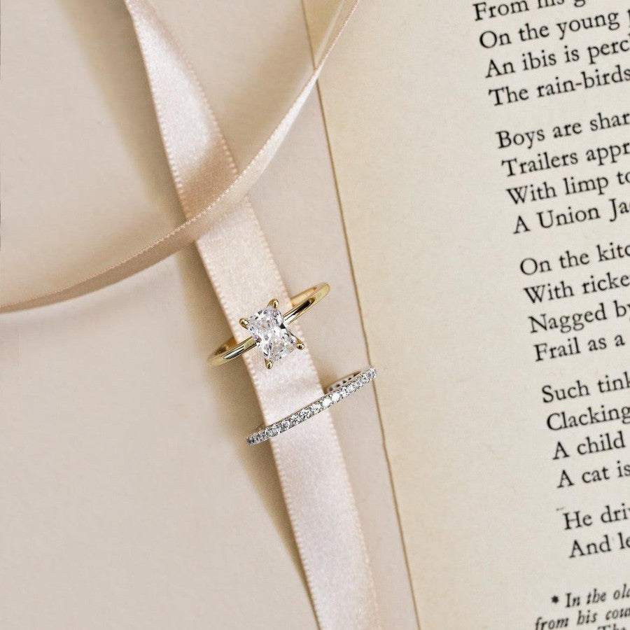 white gold diamond wedding ring and yellow gold radiant cut solitaire diamond engagement ring