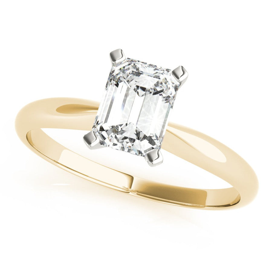 Yellow gold tapered engagement ring with emerald cut moissanite