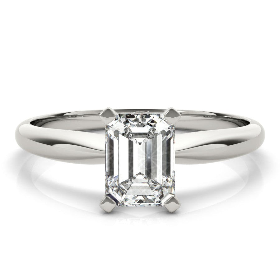 White gold tapered engagement ring with emerald cut moissanite