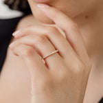 model wearing round diamond and baguette diamond wedding ring