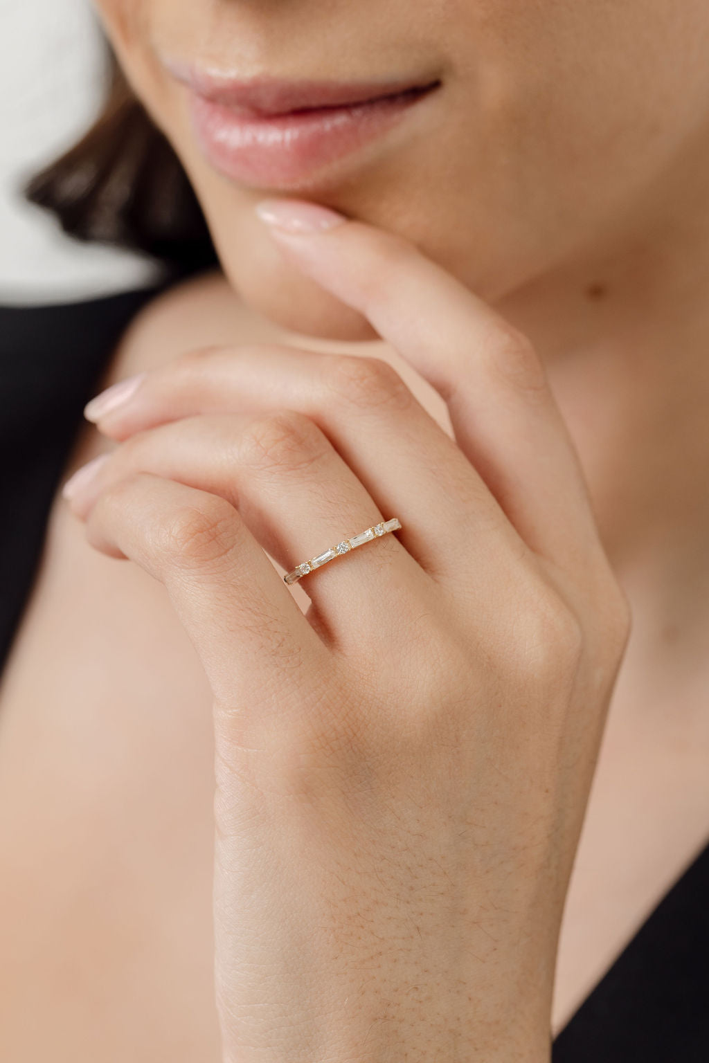 model wearing round diamond and baguette diamond wedding ring