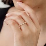 model wearing round diamond and baguette diamond wedding ring