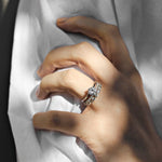 white gold round solitaire engagement ring with a diamond wedding ring with single claws on a woman with a white shirt