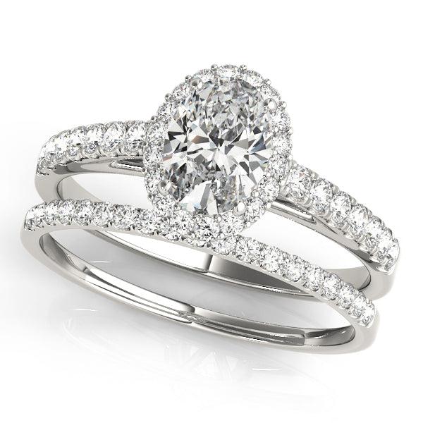 Oval diamond engagement ring with diamond halo and diamonds in the band