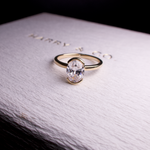 oval diamond engagement ring half bezel set in gold