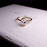 oval diamond engagement ring half bezel set in gold