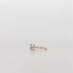 oval diamond cut engagement ring with pave set diamond band in yellow gold