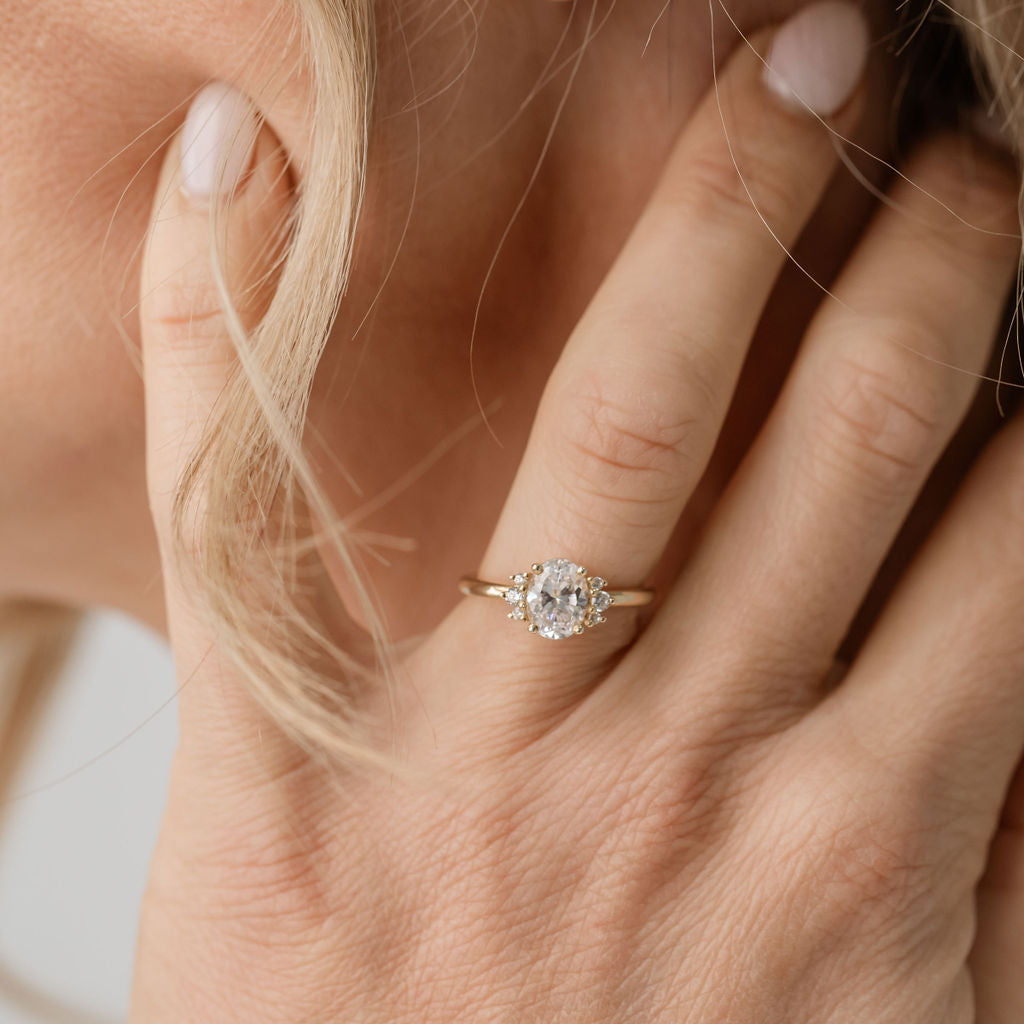 Oval engagement ring with side stones