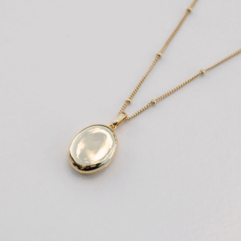 gold oval locket on bead chain necklace