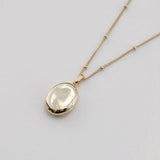 gold oval locket on bead chain necklace