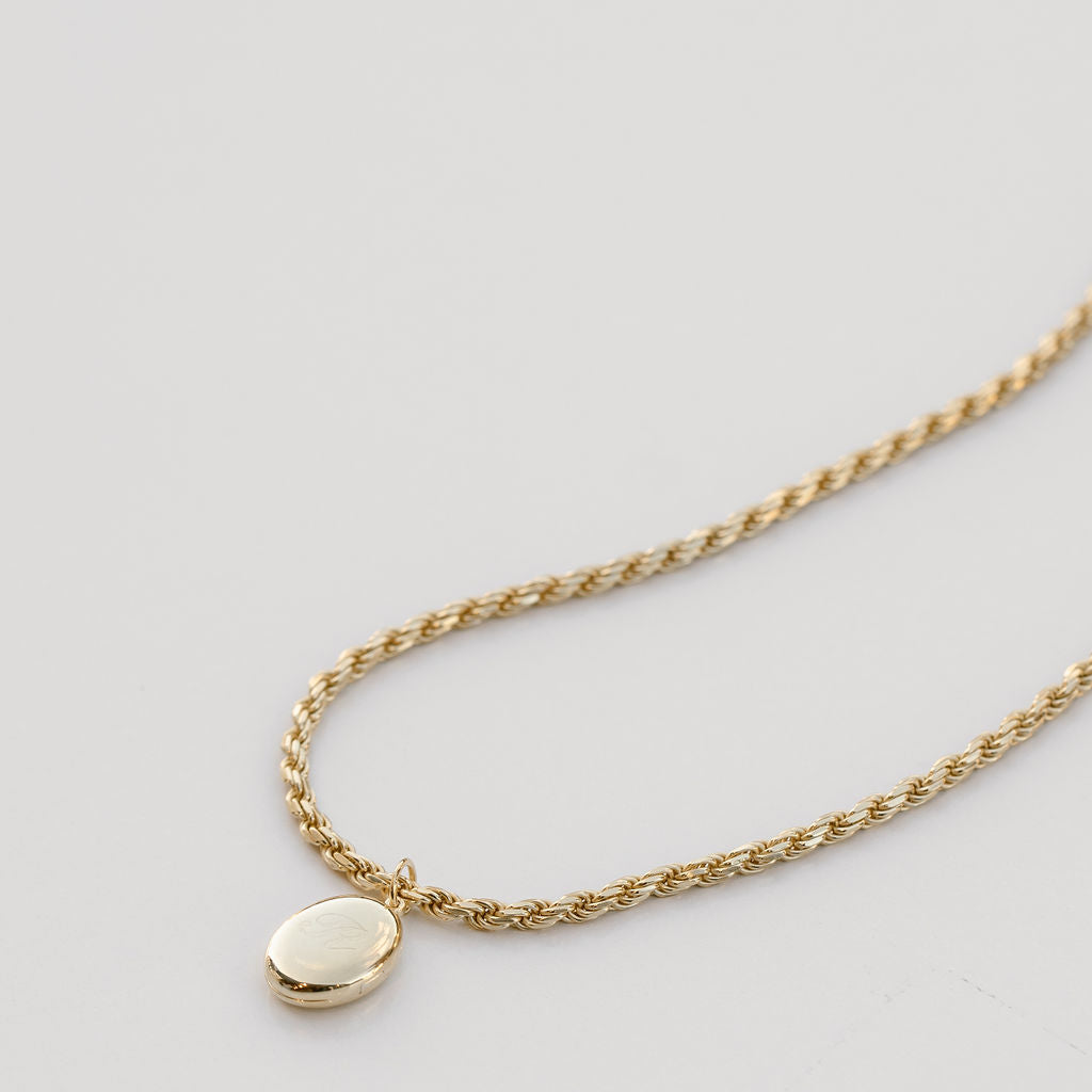oval locket on gold rope chain