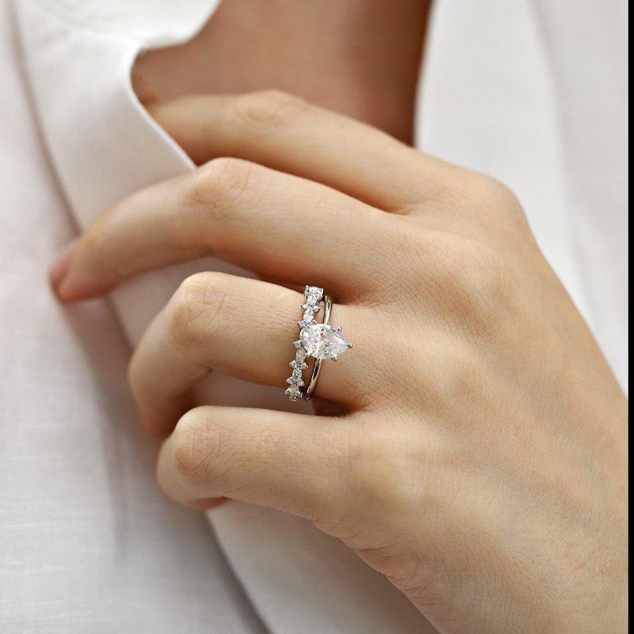White gold pear shape diamond solitaire engagement ring and white gold diamond wedding ring
