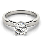 White gold pinched in solitaire with round moissanite