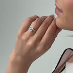 oval cut diamond engagement ring with scattered diamonds in the band