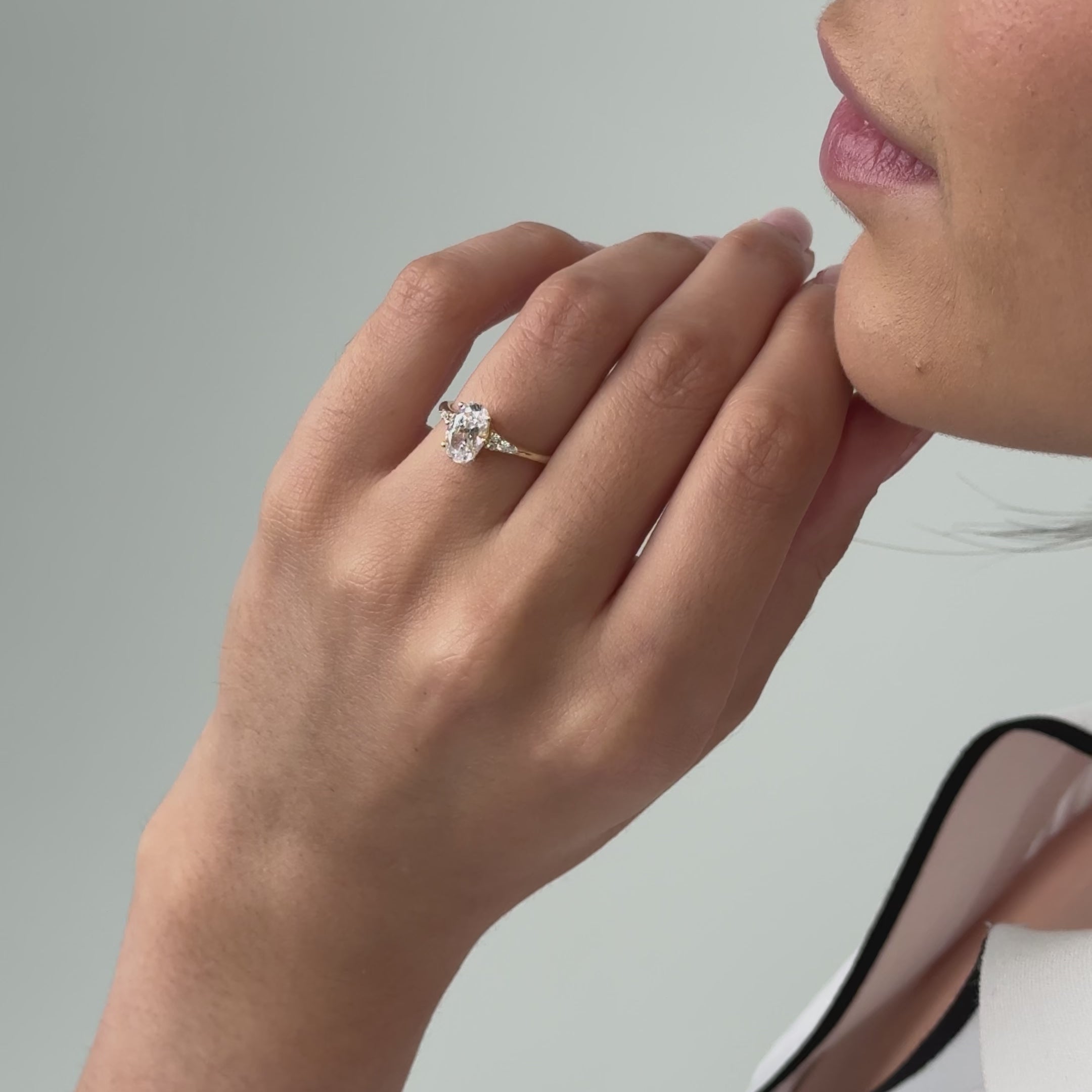 oval cut diamond engagement ring with scattered diamonds in the band