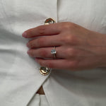 Emerald cut diamond engagement ring with diamond pave band
