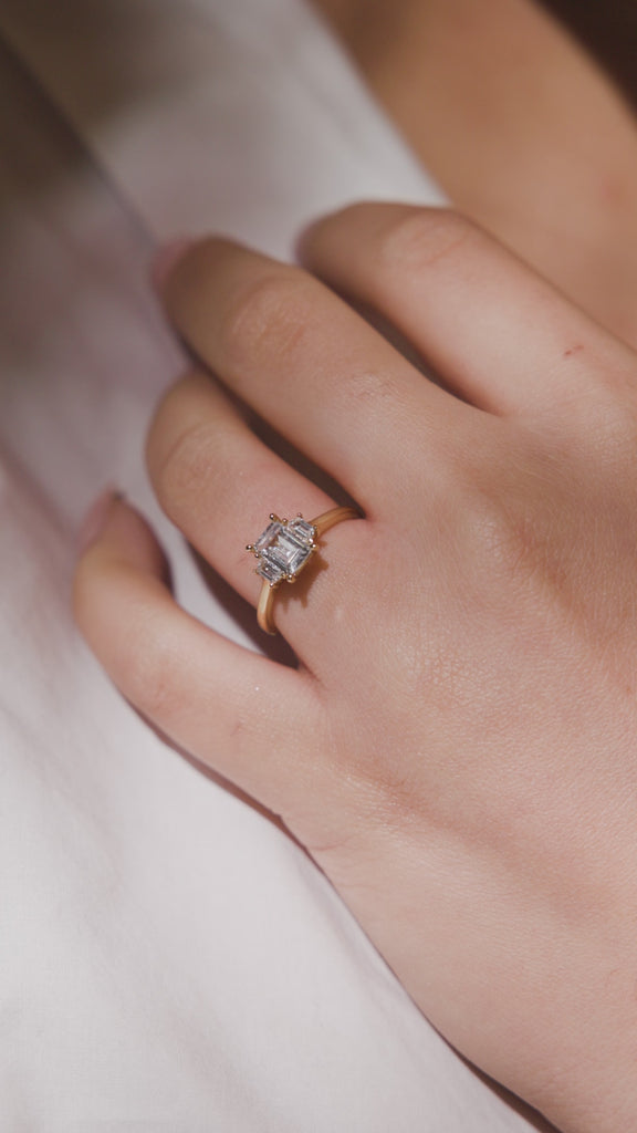 EMERALD CUT THREE STONE TRILOGY ENGAGEMENT RING
