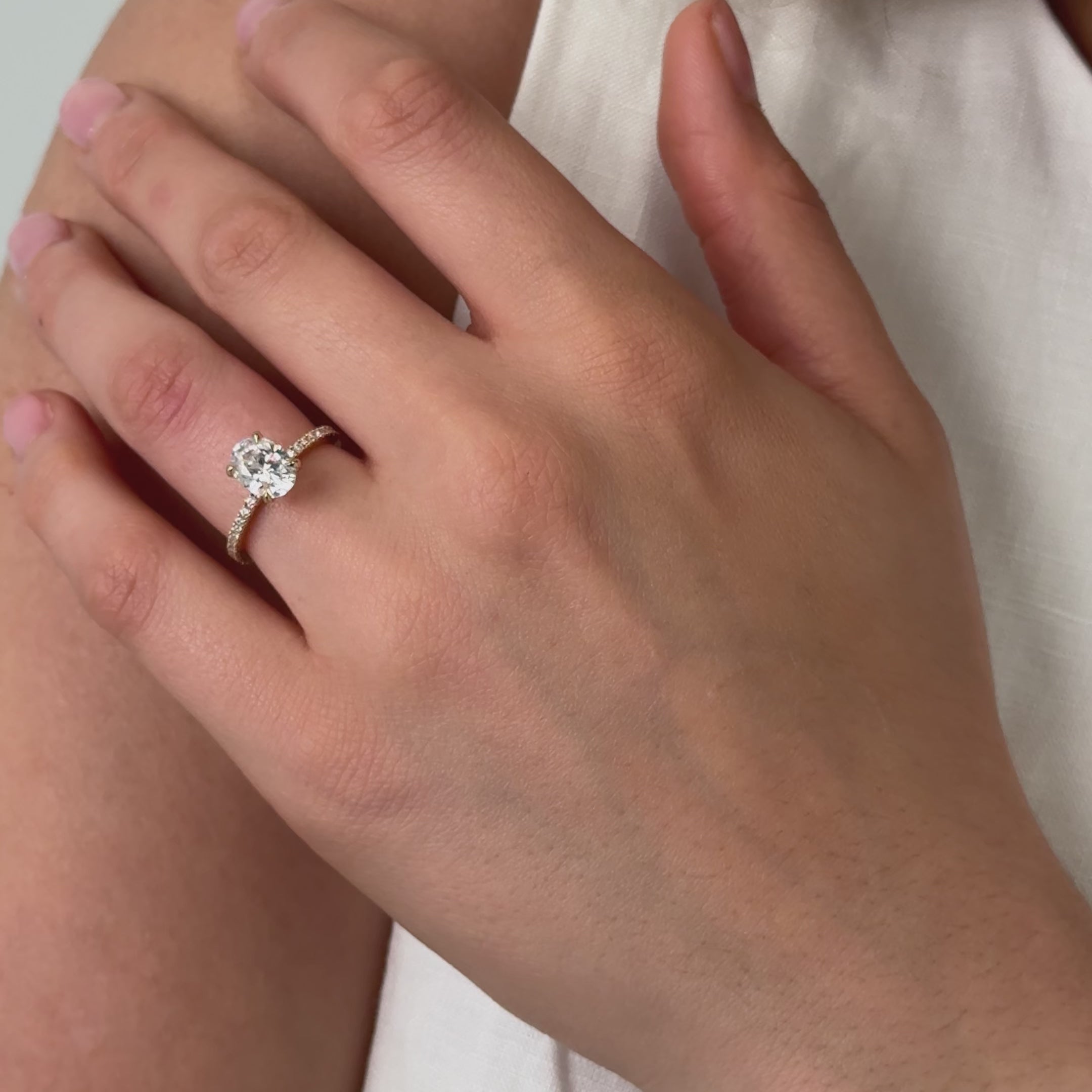 oval diamond engagement ring with pave diamonds in the band