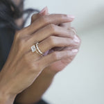 Emerald cut engagement ring set east west