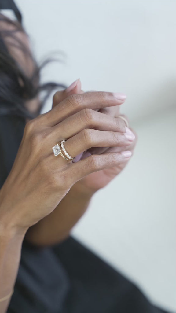 Emerald cut engagement ring set east west