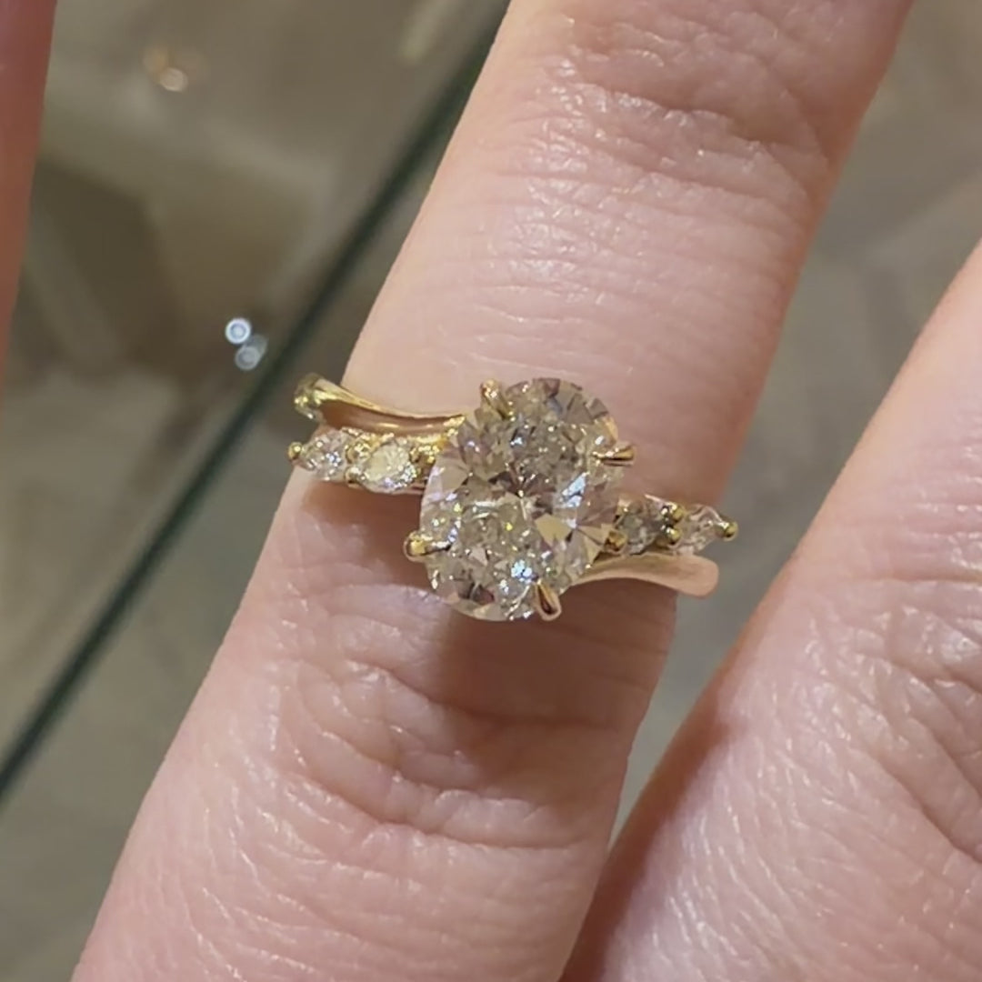 Oval Cut diamond engagement ring with marquise cut accent stones