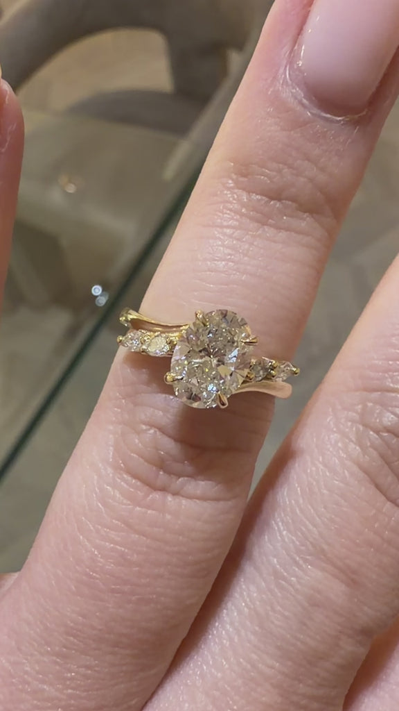 Oval Cut diamond engagement ring with marquise cut accent stones