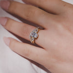Trilogy 3 stone engagement ring oval cut diamond with pear cut side stones and a pave diamond wedding ring