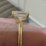 Elongated cushion cut diamond engagement ring with a hidden halo