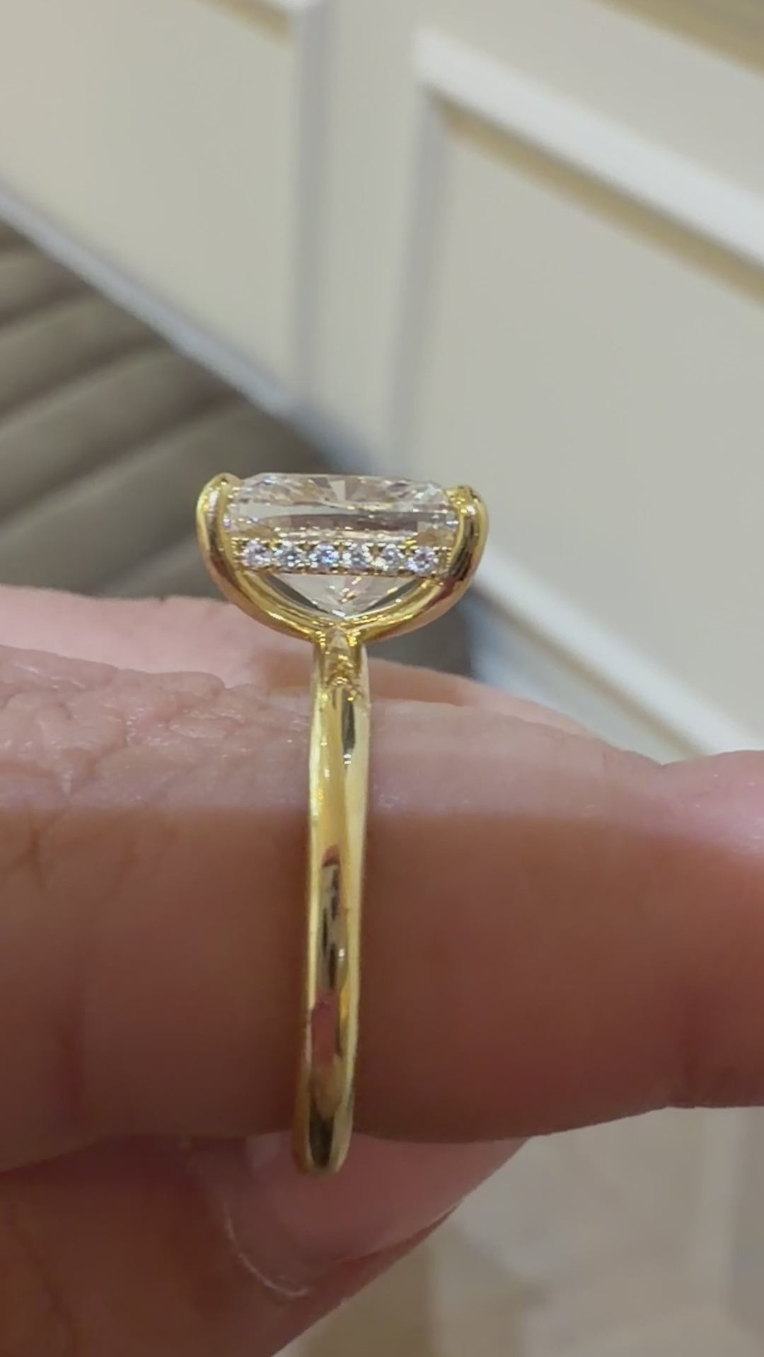 Elongated cushion cut diamond engagement ring with a hidden halo