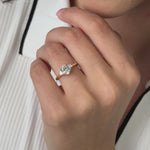 Three stone trilogy engagement ring with oval cut diamond centre