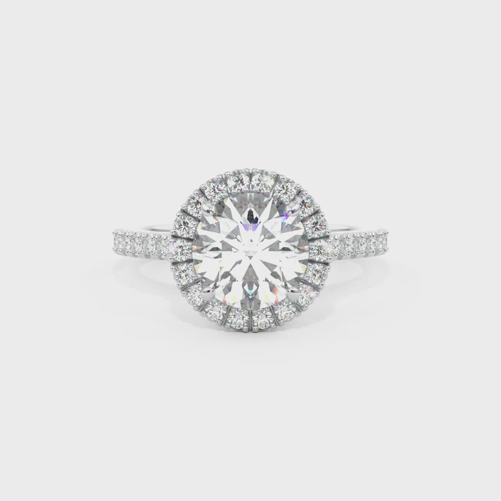 round brilliant cut diamond ring with diamond halo in platinum