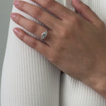 Three stone trilogy engagement ring with round cut centre stone and brilliant cut diamond side stones