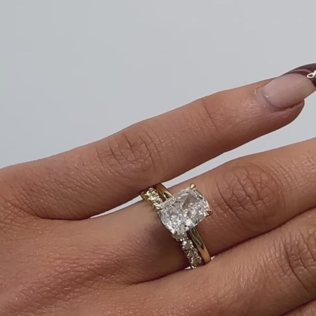Elongated cushion cut diamond solitaire engagement ring in yellow gold with diamond wedding ring