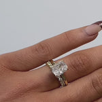 Elongated cushion cut diamond solitaire engagement ring in yellow gold with diamond wedding ring