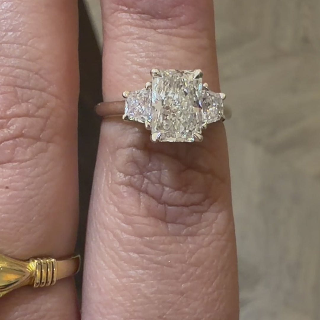 3 stone diamond engagement ring with radiant cut centre diamond