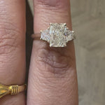 3 stone diamond engagement ring with radiant cut centre diamond