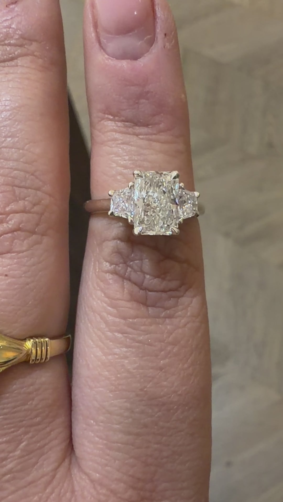 3 stone diamond engagement ring with radiant cut centre diamond