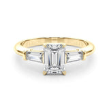 Three stone engagement ring with emerald cut centre and side stones