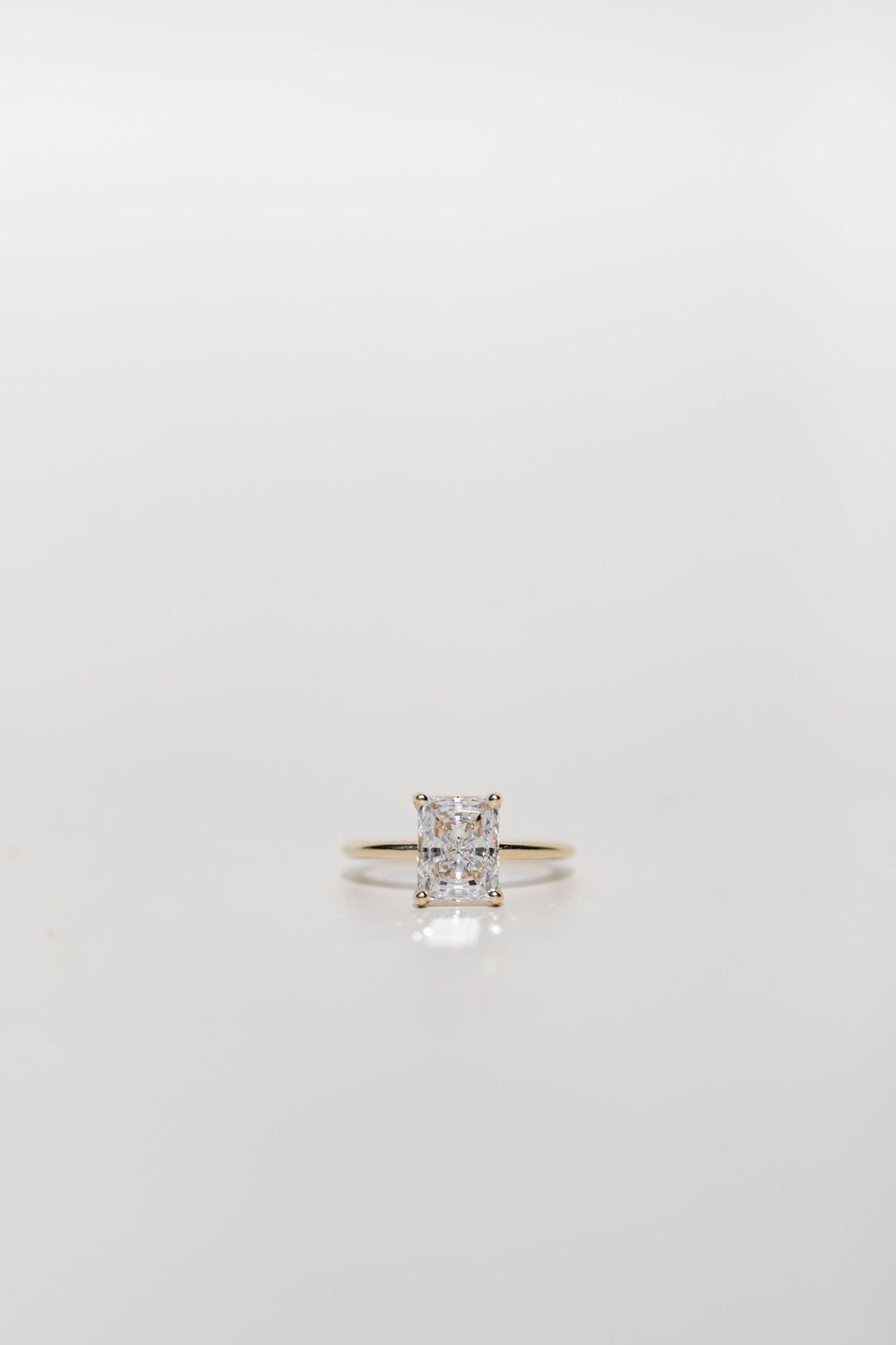 radiant cut diamond solitaire engagement ring in yellow gold
