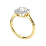 Halo engagement ring with an elongated cushion cut centre stone, diamond halo and millgrain edge