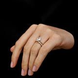 Pear engagement ring with diamond band