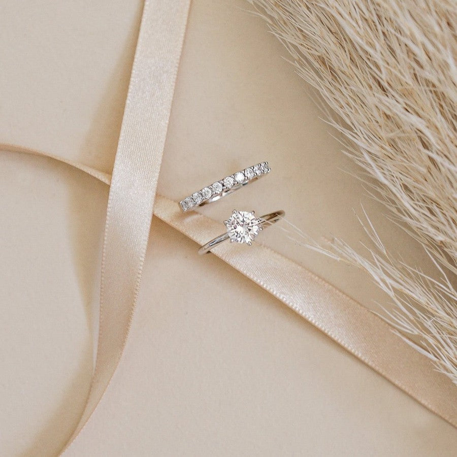 white gold round diamond solitaire engagement ring and white gold diamond wedding ring