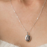 silver oval locket engraved on chain