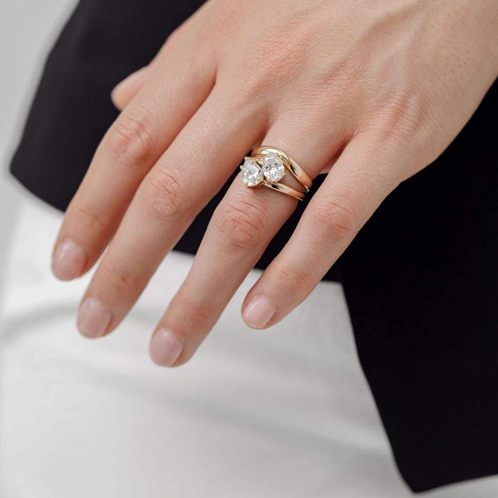 toi et moi diamond engagement ring with yellow gold curved wedding ring
