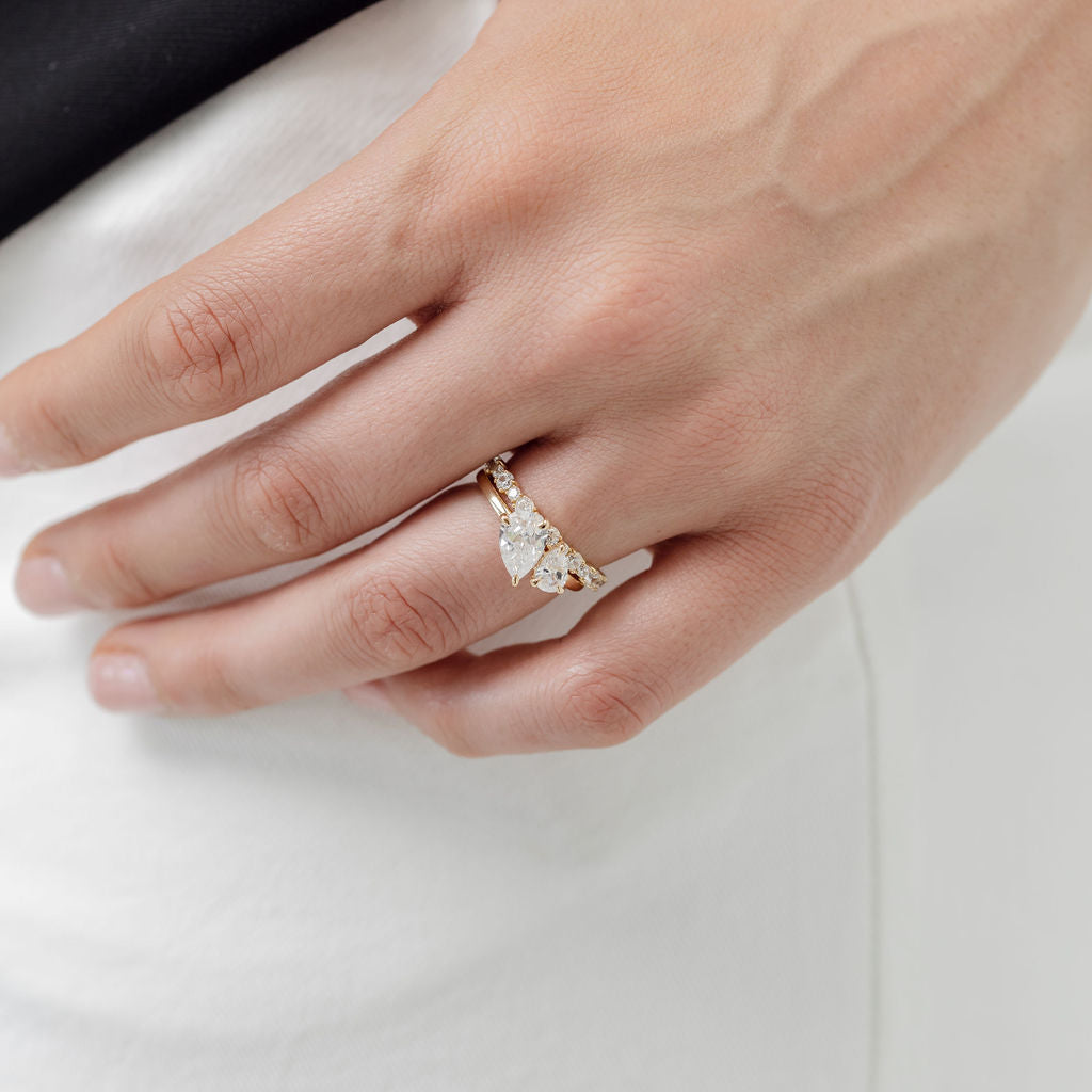 toi et moi pear cut diamond ring with diamond wedding ring
